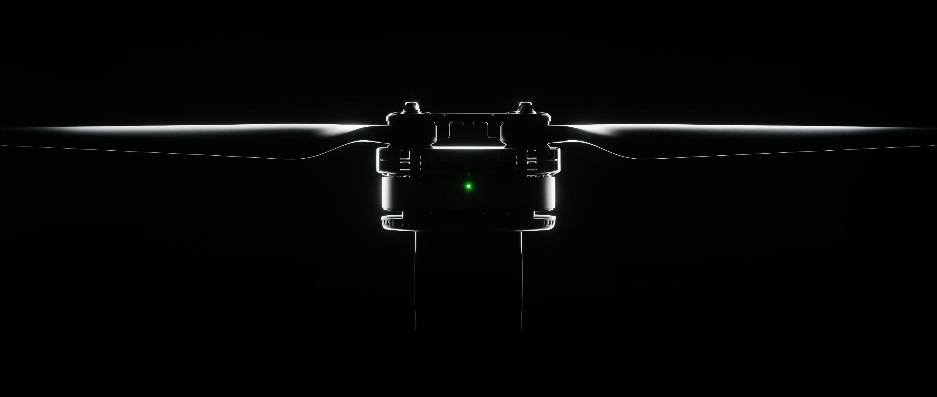 Dramatic backlit close-up of a drone propeller and motor